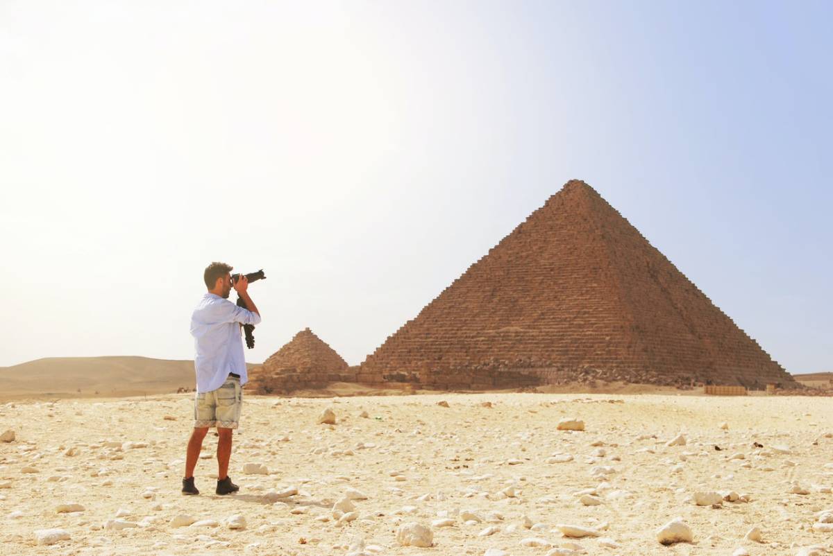 a man taking pics of a pyramid